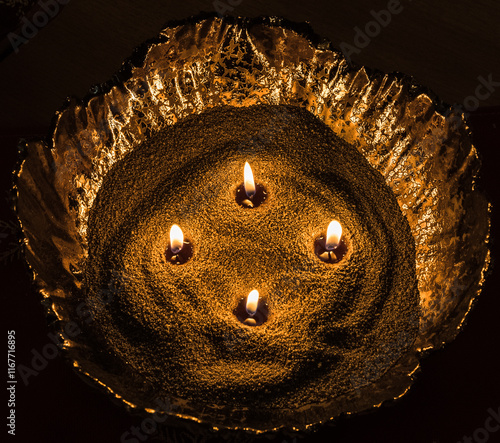 An interestingly designed candle is filled with bulk stearin pearls in a special ceramic container, in which four wicks are inserted. A beautifully burning candle. photo