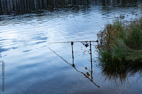 Fishing rod set up by the lake photo