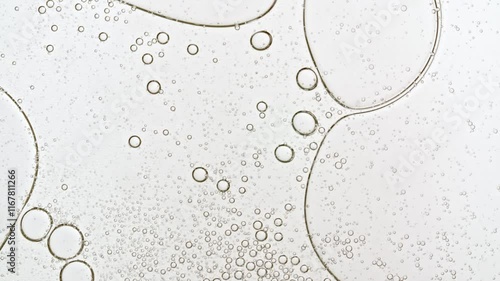 Transparent cosmetic gel fluid with molecule bubbles oil distribution. Bubble cluster, cells under a microscope. Macro Shot of Natural Organic Cosmetics, Medicine. Production Close-up. Slow Motion. 4k