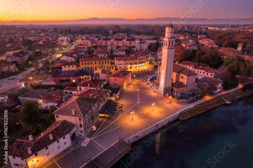 Aerial View of Casier harbour at Sunset during Christmas time with Bell Tower and Mountain Backdrop
