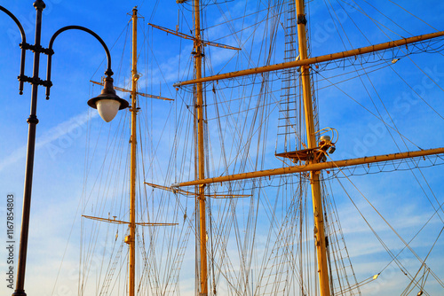 View of the masts and rigging of a sailing ship close-up against the background of sky in the port of Varna, on the Black Sea coast of Bulgaria photo