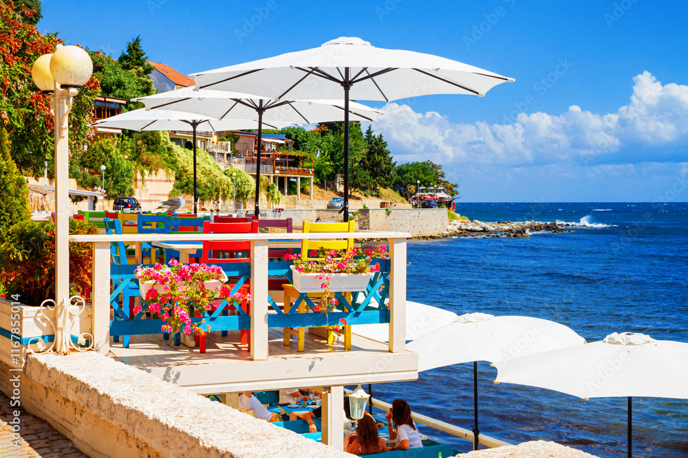 Seaside landscape - view of the cafe on the embankment by the sea, in the Old Town of Nessebar, on the Black Sea coast of Bulgaria