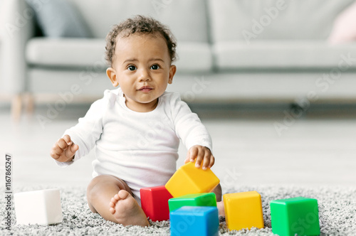 Adorable Black Infant Baby Playing With Stacking Building Blocks At Home While Sitting On Carpet In Living Room, Portrait Of Cute African American Child Using Colorful Constructor Toys, Copy Space