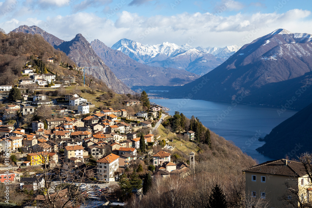 Fototapeta premium View from Monte Bre of the village, Lake Lugano, and surrounding mountains, Switzerland