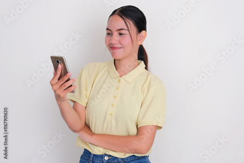 A woman smiling when staring at her mobile phone photo