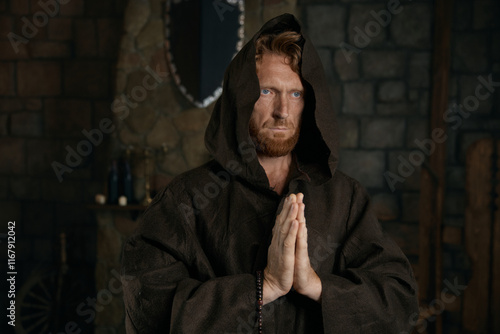 Portrait of blessed priest praying having faith believe in God photo