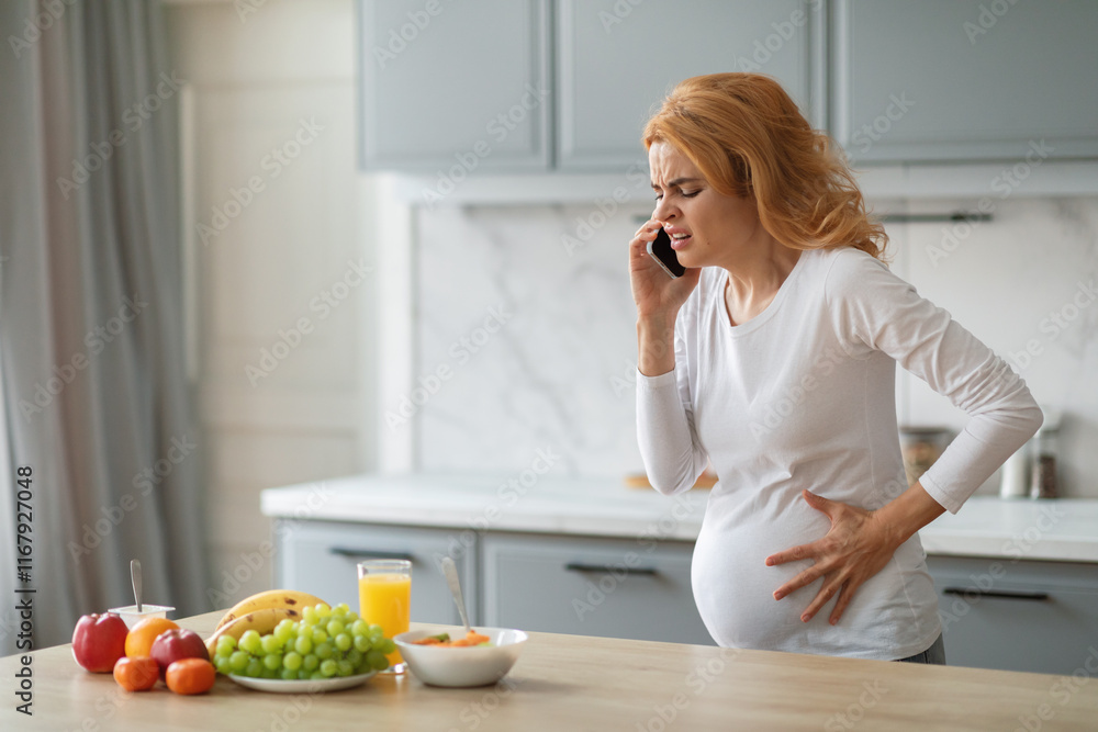 A pregnant woman stands in her kitchen, one hand on her belly while talking on the phone with a concerned expression. Fresh fruits are on the counter, highlighting her home environment, copy space A pregnant woman stands in her kitchen, one hand on her belly while talking on the phone with a concerned expression. Fresh fruits are on the counter, highlighting her home environment, copy space