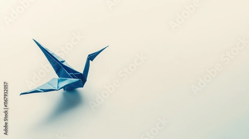 A blue origami crane on a minimalistic background, symbolizing peace and creativity. photo