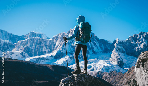 Backpacking woman hiking on high altitude mountain top photo