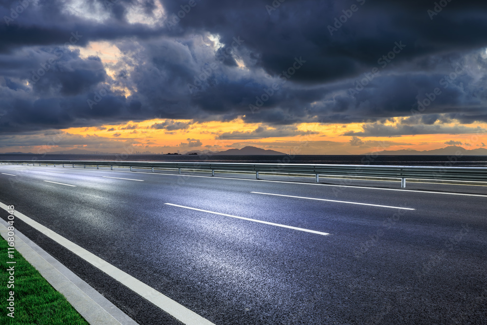 Naklejka premium Asphalt highway road and beautiful coastline nature landscape at dusk. Outdoor road background.