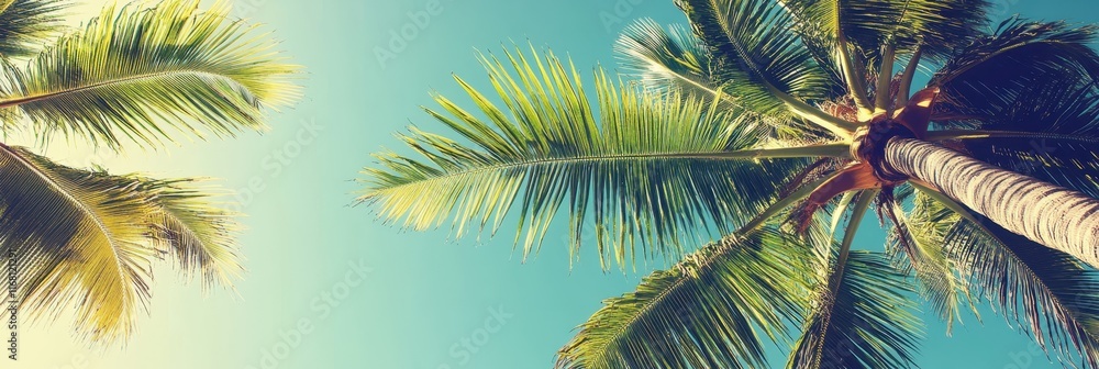 Fototapeta premium Tropical beach paradise, palm trees against turquoise sky, retro color palette, vintage postcard aesthetic, sun-drenched atmosphere, low angle view, coconut palms silhouettes, summer vacation vibes, d