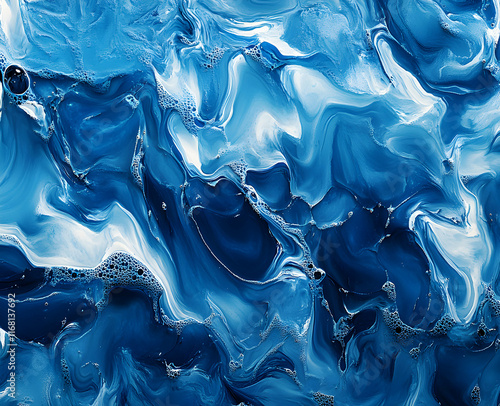 Abstract Blue Swirls: A mesmerizing fluid art piece showcasing the beauty of blended colors and textures. Deep blues and whites intertwine, creating a dynamic and captivating visual experience. photo