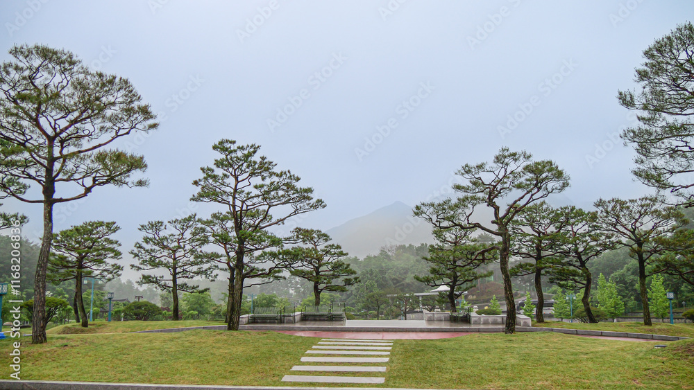 Hapcheon-gun, Gyeongsangnam-do, South Korea - tourists are walking on dirt road besides Colonial Japanese House and clothes store at Hapcheon Film Theme Park Morning view of photo studio and shops fo Hapcheon-gun, Gyeongsangnam-do, South Korea - tourists are walking on dirt road besides Colonial Japanese House and clothes store at Hapcheon Film Theme Park Morning view of photo studio and shops fo
