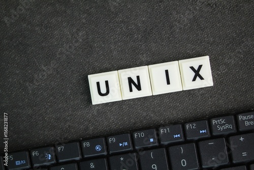 laptop keyboard with the word unix. an operating system analogous to DOS and Windows, supporting multiple concurrent users photo