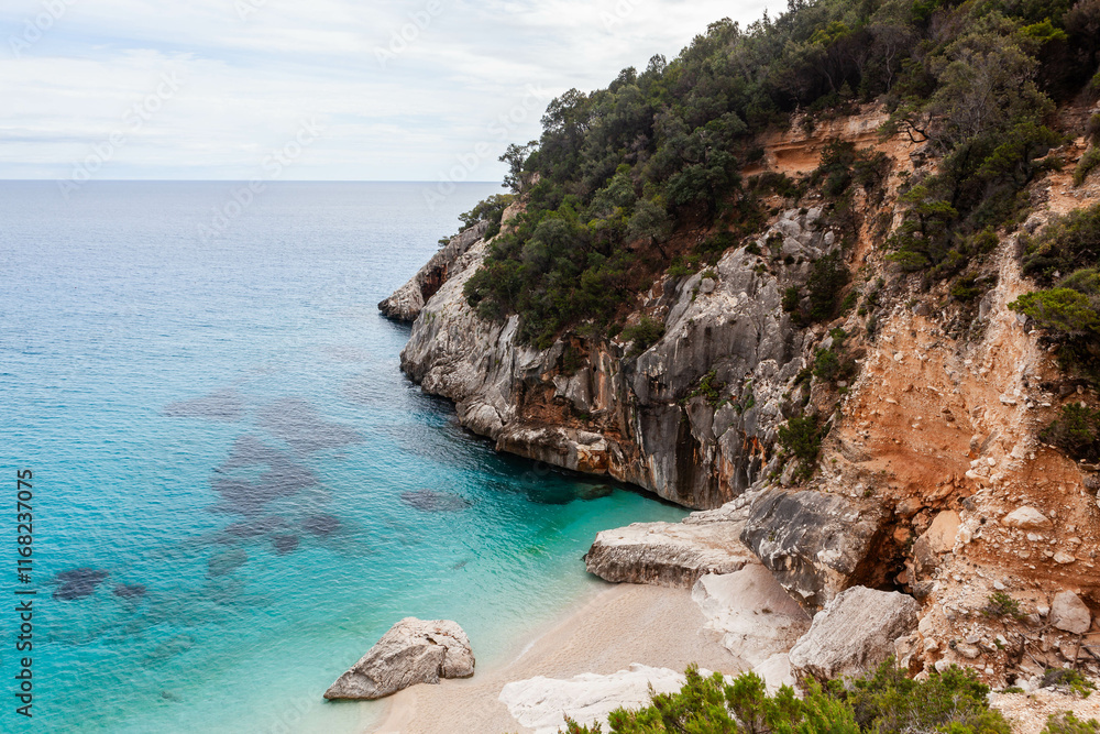 Cala Goloritze. Awesome beach on the eastern coast of Sardinia. Crystal clear Mediterranean sea and cliffs of Gulf of Orosei. Baunei area, Sardinia, Italy. Cala Goloritze. Awesome beach on the eastern coast of Sardinia. Crystal clear Mediterranean sea and cliffs of Gulf of Orosei. Baunei area, Sardinia, Italy.