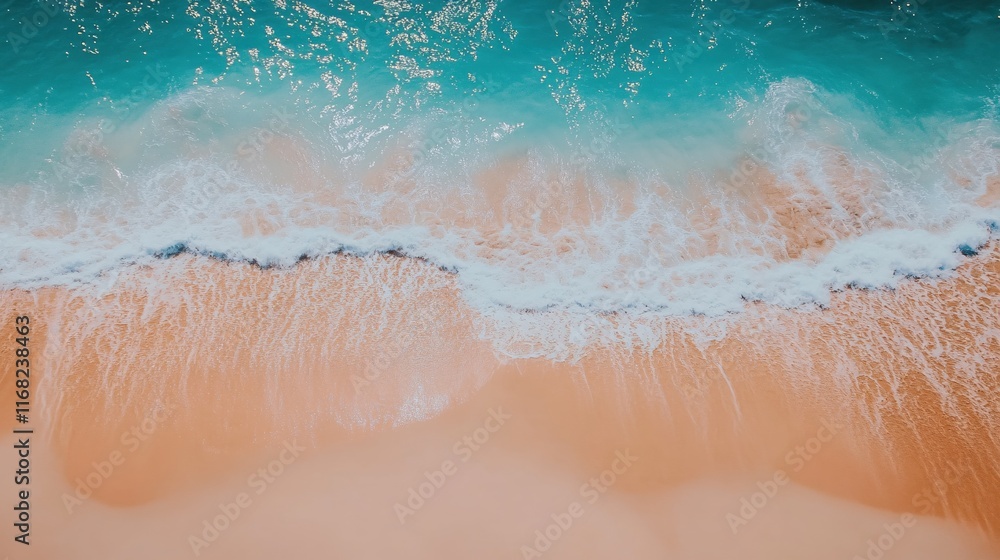 Fototapeta premium Aerial View of Clear Ocean Waves Gently Rolling onto Sandy Beach Shoreline