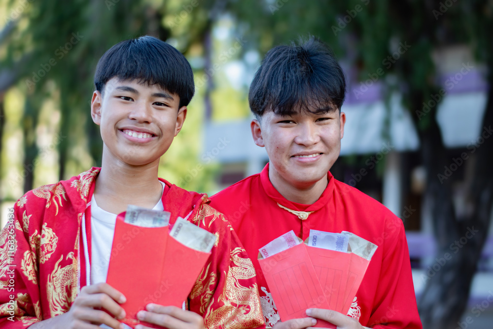Happy Chinese new year, Chinese boy smiles happily after receiving several red red envelopes or 'hong bao' during the annual Chinese New Year festival. Happy Chinese new year, Chinese boy smiles happily after receiving several red red envelopes or 'hong bao' during the annual Chinese New Year festival.