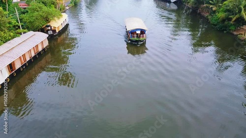 Indian lake tourism , Kumarakam water pollution due to the use of petrol in shikkara ride .world tourism spot ,Aerial view of Kerala's backwaters with rows of houseboats lined photo