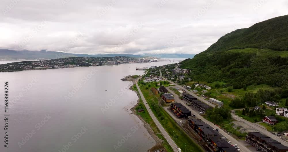 European Route E8 Along The Waterfront Condominium Complex In Tromso, Norway. - aerial shot European Route E8 Along The Waterfront Condominium Complex In Tromso, Norway. - aerial shot