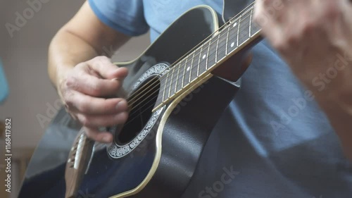 A man plays an acoustic guitar