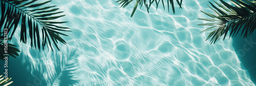 A top-down view of a crystal-clear swimming pool with rippling water reflecting sunlight, creating soft waves and patterns