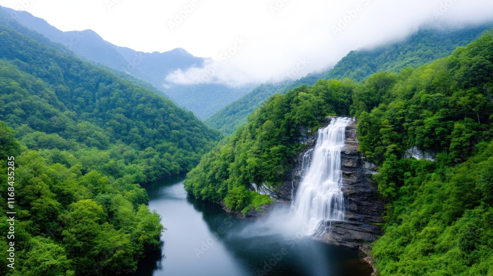 Fototapeta premium Serene waterfall cascading into a tranquil river amidst lush mountains.