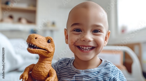 Brave little fighter: Smiling bald boy in a hospital room holding his favorite toy – a heartwarming cancer awareness concept.