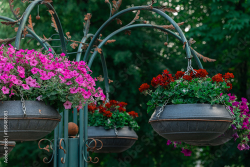 hanging flower pot on forged decorative pillar park city square landscaped object close up spring season specific outdoor environment photo