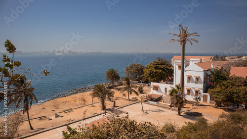 Slave trade houses on the famous island of Goree in the atlantic ocean just outside of Dakar city. Dakar skyline is seen in the background, great panoramic photo of a sad island.