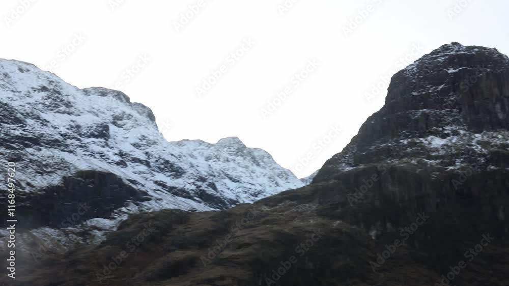 Telephoto panning shot of the snowy summits of Bidean Nam Bian on a bluebird day Telephoto panning shot of the snowy summits of Bidean Nam Bian on a bluebird day
