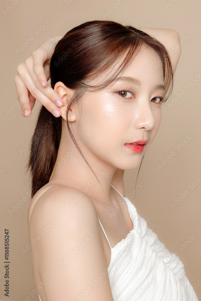 Young Asian beauty woman pulled back hair with korean makeup style on face and perfect skin on isolated beige background. Facial treatment, Cosmetology, plastic surgery. Young Asian beauty woman pulled back hair with korean makeup style on face and perfect skin on isolated beige background. Facial treatment, Cosmetology, plastic surgery.