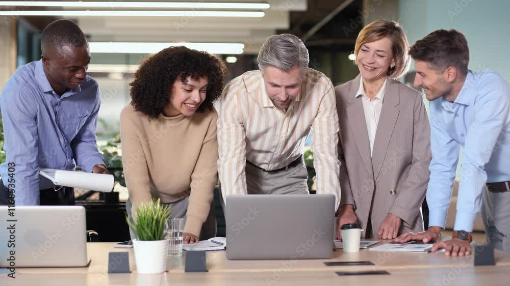 Successful businesspeople working in a coworking space working with laptop discussing strategy and business plan in modern office. Successful businesspeople working in a coworking space working with laptop discussing strategy and business plan in modern office.