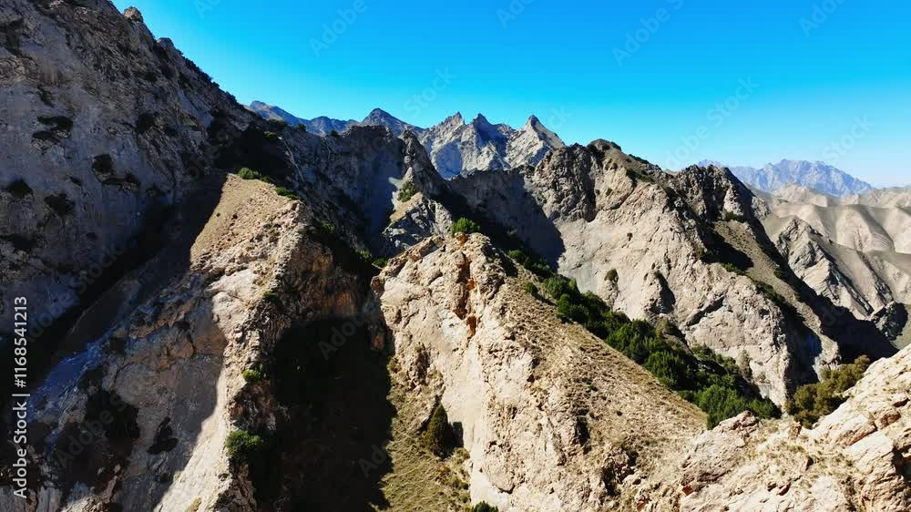 Stunning mountain landscape with rugged terrain and clear blue skies in a remote location Stunning mountain landscape with rugged terrain and clear blue skies in a remote location