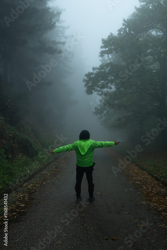 man walking in the fog forest
