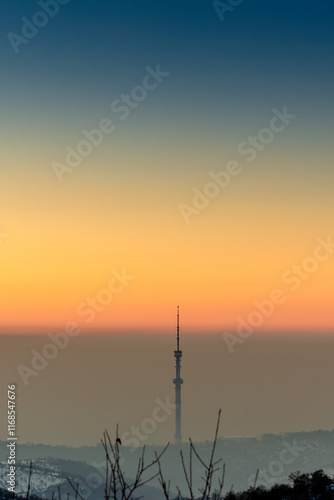 Colorful sunset in a clear sky above cities smog with  the TV tower