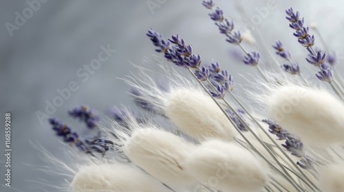 Delicate arrangement of lavender and fluffy white flowers on a soft surface