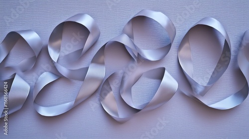 Elegant silver ribbons arranged artistically on a textured background. photo