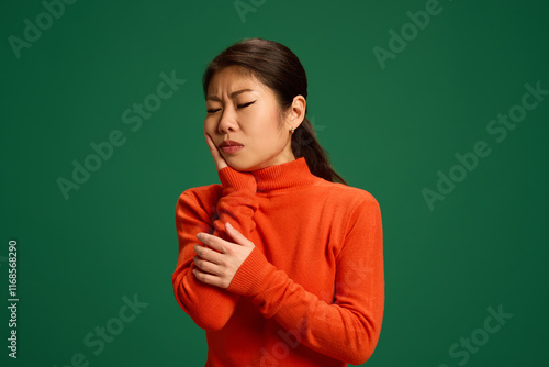 Woman holding jaw with visible discomfort, possibly due to dental infection or viral swelling. Highlights healthcare importance for oral pain management. Concept of healthcare, medicine, infection. Ad