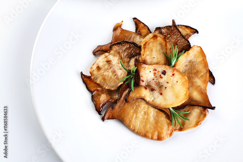 Fried Pleurotus eryngii mushrooms on a white plate. photo