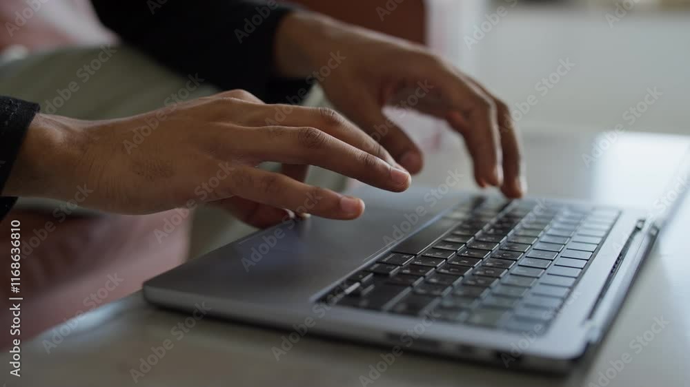 Close-up of hands browsing online on a laptop keyboard in a modern workspace Close-up of hands browsing online on a laptop keyboard in a modern workspace