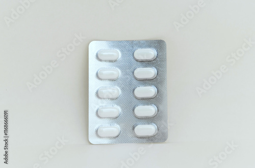 Blister pack of tablets on beige background, close-up. Pharmaceutical industry concept, medicine, treatment