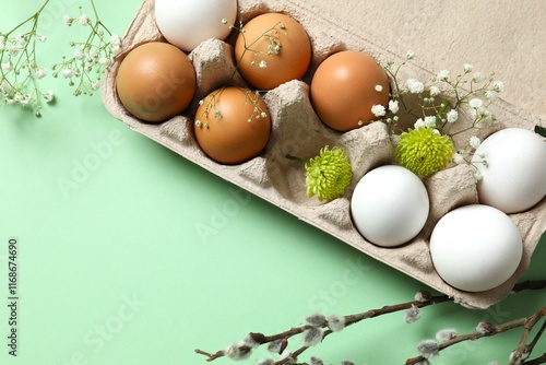 Chicken eggs in a cardboard package with flowers photo