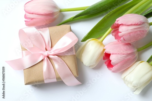 Beautiful fresh tulips with a gift box on color background