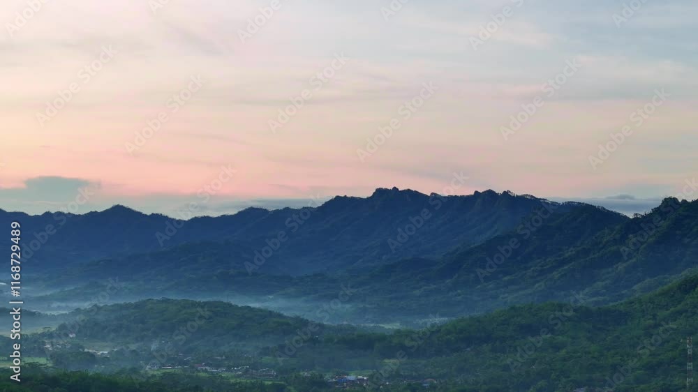 Aerial scenery of Menoreh hill in slightly foggy morning, Indonesia. Beautiful rural scenery of Indonesia. Mountain natural landscape in the morning. 4K drone footage. Aerial scenery of Menoreh hill in slightly foggy morning, Indonesia. Beautiful rural scenery of Indonesia. Mountain natural landscape in the morning. 4K drone footage.