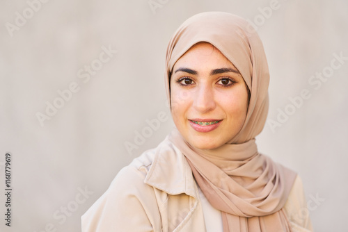 Young arab woman smiling and wearing hijab
