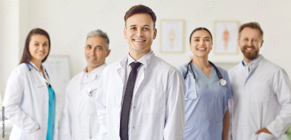 Fototapeta premium Group of happy doctors standing in the office, close-up. Concept of a professional ambulance team. Portrait of hospital staff in uniform with stethoscopes. Therapy team meeting, community