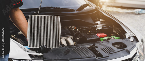 Car care maintenance servicing technician or auto mechanic holding car air conditioner filter for check and clean dirty or fix repair heat have engine problem or replace new change air filter. photo