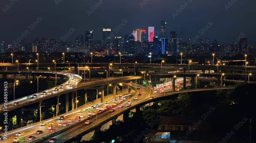 Beautiful city skyline illuminated at night with bustling highways and traffic visible in the foreground Beautiful city skyline illuminated at night with bustling highways and traffic visible in the foreground