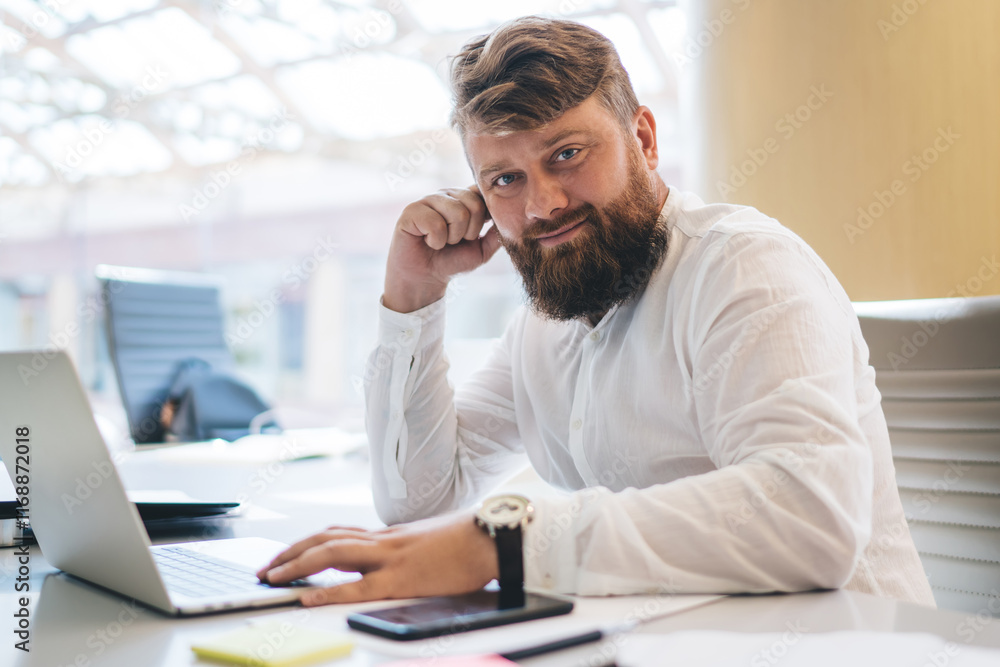 Portrait of handsome male employee posing at table desktop with digital netbook computer on it,Caucasian man in smart casual apparel looking at camera using coworking internet connection for freelance Portrait of handsome male employee posing at table desktop with digital netbook computer on it,Caucasian man in smart casual apparel looking at camera using coworking internet connection for freelance