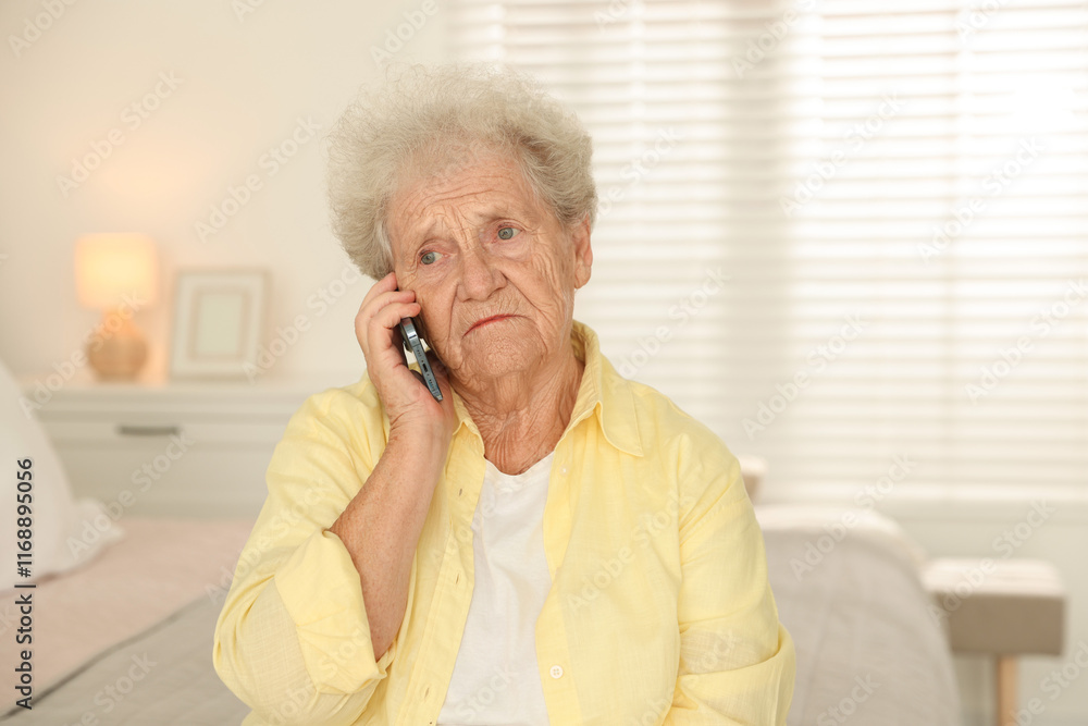 Senior woman talking on smartphone at home Senior woman talking on smartphone at home
